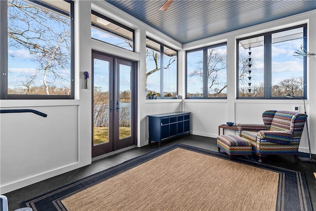 sunroom featuring french doors and baseboards