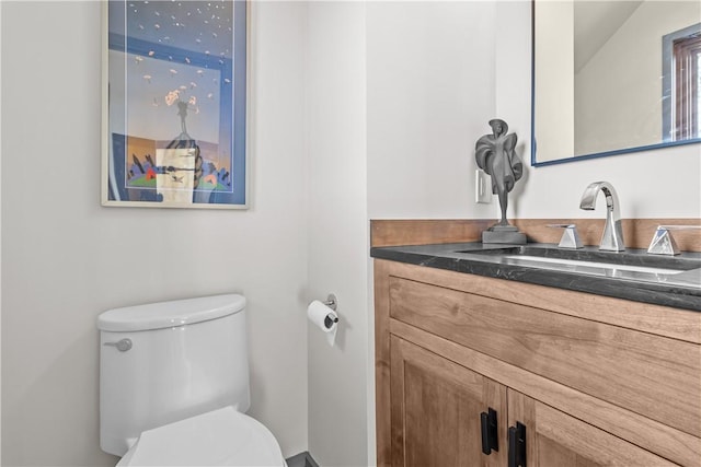 half bathroom featuring toilet and vanity