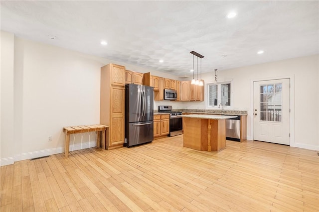 982 Plainfield St Unit 4, Johnston, RI 02919 - kitchen with appliances with stainless steel finishes, a center island, light wood-style floors, light countertops, and recessed lighting