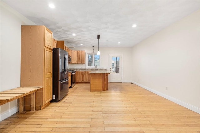 982 Plainfield St Unit 4, Johnston, RI 02919 - kitchen with appliances with stainless steel finishes, light wood-style floors, a kitchen island, recessed lighting, and light countertops