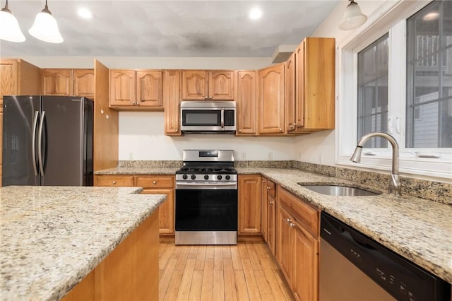 982 Plainfield St Unit 4, Johnston, RI 02919 - kitchen with stainless steel appliances, a sink, light wood-style flooring, light stone countertops, and recessed lighting
