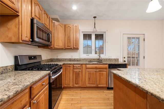 982 Plainfield St Unit 4, Johnston, RI 02919 - kitchen featuring stainless steel appliances, light wood-style flooring, a sink, light stone countertops, and recessed lighting