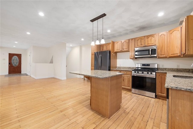982 Plainfield St Unit 4, Johnston, RI 02919 - kitchen with appliances with stainless steel finishes, a sink, a center island, light stone countertops, and recessed lighting