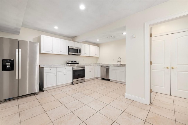 982 Plainfield St Unit 4, Johnston, RI 02919 - kitchen featuring stainless steel appliances, light countertops, light tile patterned flooring, white cabinets, and recessed lighting