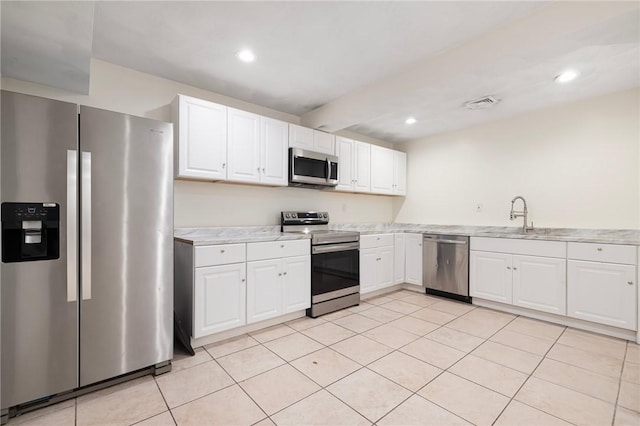 982 Plainfield St Unit 4, Johnston, RI 02919 - kitchen featuring stainless steel appliances, a sink, light countertops, white cabinets, and light tile patterned floors