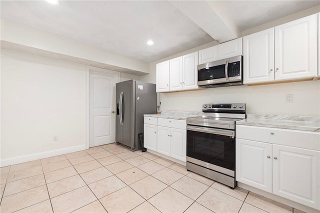 982 Plainfield St Unit 4, Johnston, RI 02919 - kitchen with stainless steel appliances, light countertops, white cabinets, light tile patterned flooring, and recessed lighting