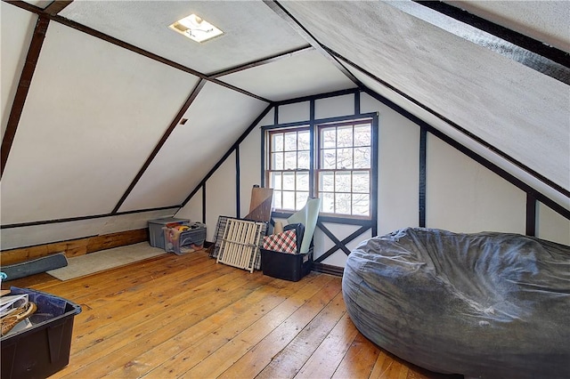 bonus room with hardwood / wood-style flooring and lofted ceiling