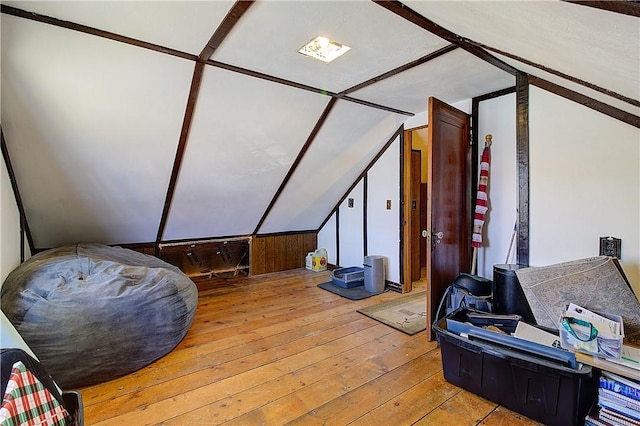 additional living space featuring hardwood / wood-style floors and lofted ceiling