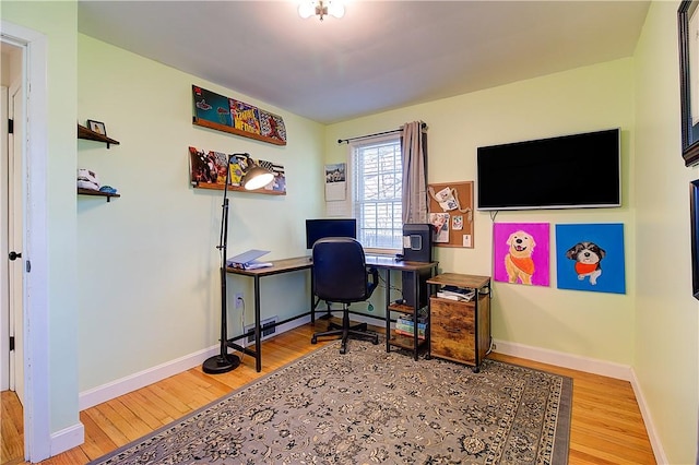 home office featuring wood finished floors and baseboards