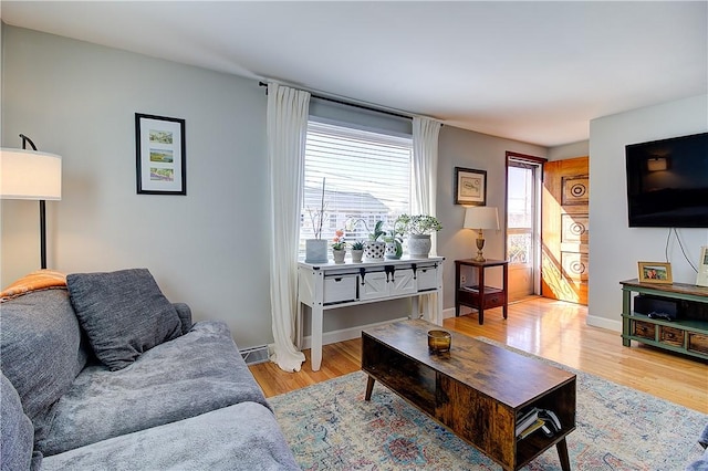 living room with light wood-style flooring and baseboards