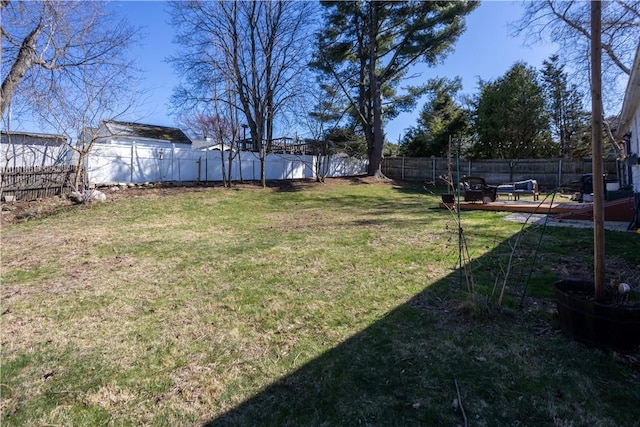 view of yard with a deck and a fenced backyard