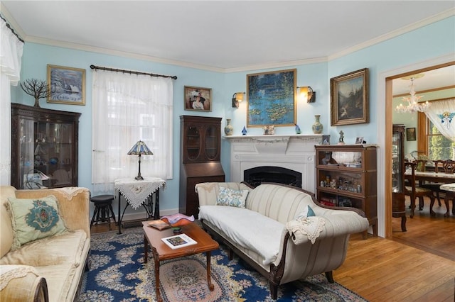 55 Hunter Ave, Newport, RI 02840 - living room featuring an inviting chandelier, crown molding, a fireplace, and wood finished floors