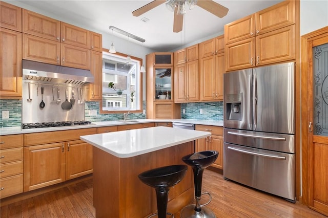 55 Hunter Ave, Newport, RI 02840 - kitchen featuring light countertops, stainless steel refrigerator with ice dispenser, gas stovetop, under cabinet range hood, and a ceiling fan
