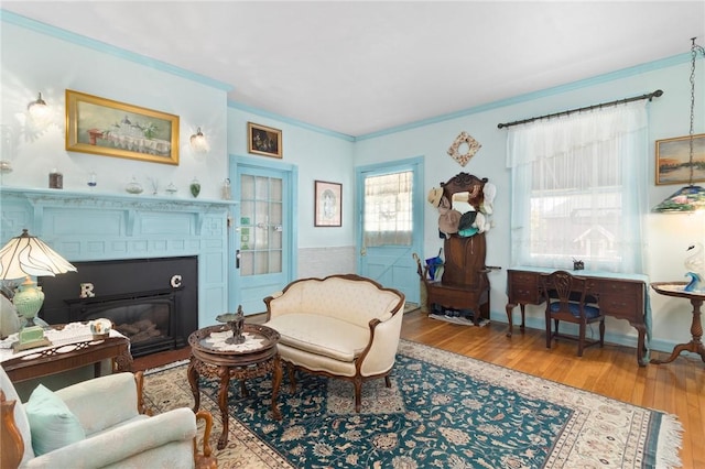55 Hunter Ave, Newport, RI 02840 - living area featuring baseboards, wood finished floors, a glass covered fireplace, and crown molding