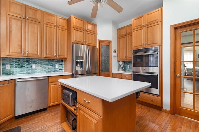 55 Hunter Ave, Newport, RI 02840 - kitchen with light countertops, light wood-style floors, ceiling fan, and stainless steel appliances
