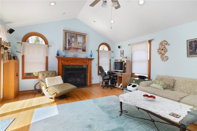 55 Hunter Ave, Newport, RI 02840 - living area featuring a fireplace with flush hearth, wood finished floors, vaulted ceiling, and a ceiling fan