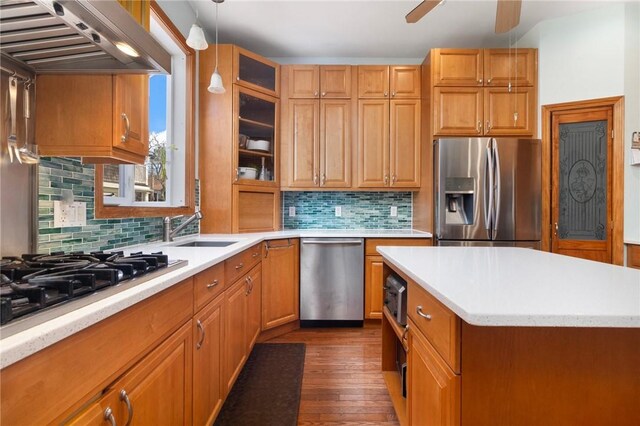 55 Hunter Ave, Newport, RI 02840 - kitchen featuring light countertops, a sink, wall chimney exhaust hood, appliances with stainless steel finishes, and dark wood finished floors