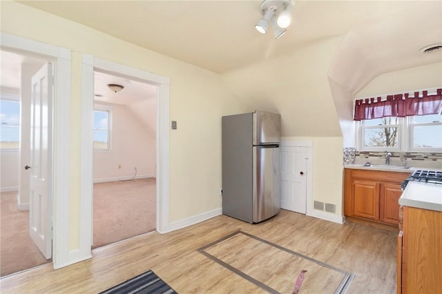 55 Hunter Ave, Newport, RI 02840 - kitchen with a wealth of natural light, light countertops, a sink, and freestanding refrigerator