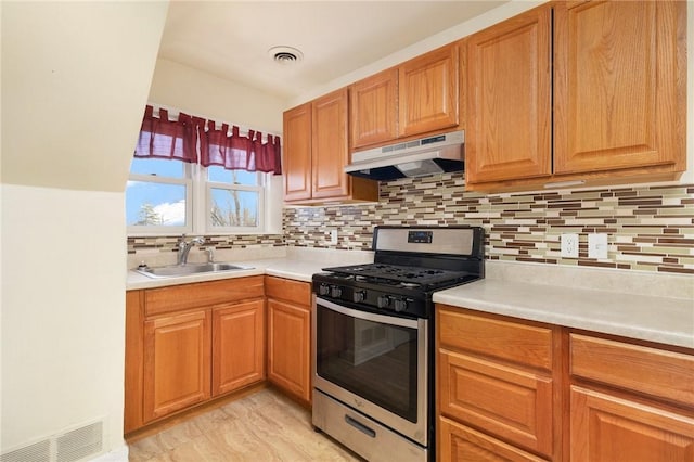 55 Hunter Ave, Newport, RI 02840 - kitchen with visible vents, stainless steel gas stove, under cabinet range hood, and a sink