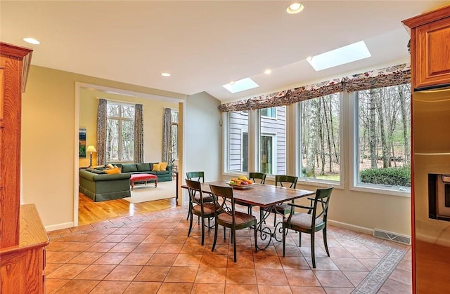 dining room with recessed lighting, baseboards, light tile patterned floors, a skylight, and visible vents