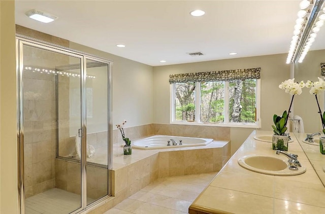 full bathroom featuring a garden tub, visible vents, a stall shower, a sink, and tile patterned floors
