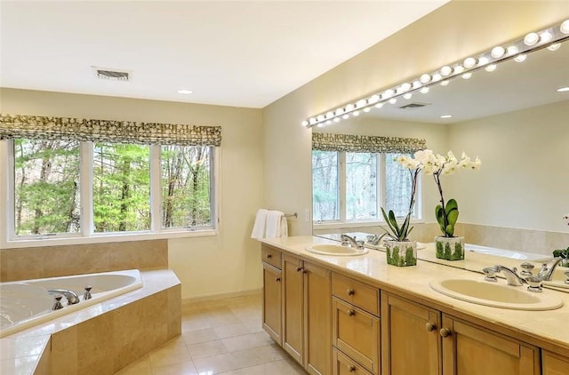 bathroom featuring visible vents, a sink, and plenty of natural light