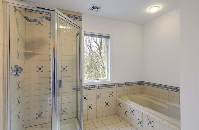 full bath with tile patterned flooring, a garden tub, a stall shower, and visible vents