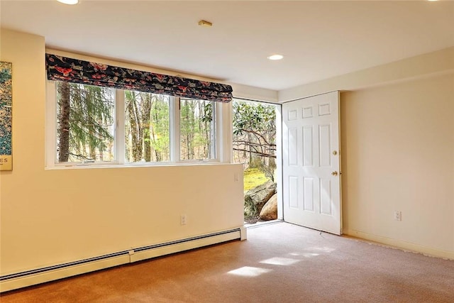 spare room with a healthy amount of sunlight, recessed lighting, a baseboard heating unit, and carpet flooring
