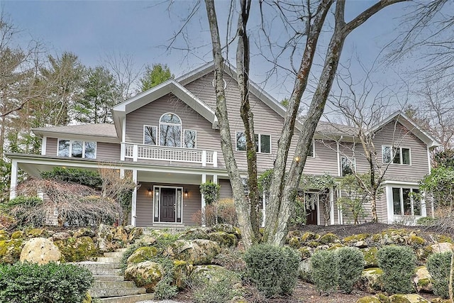 view of front of home featuring covered porch and a balcony