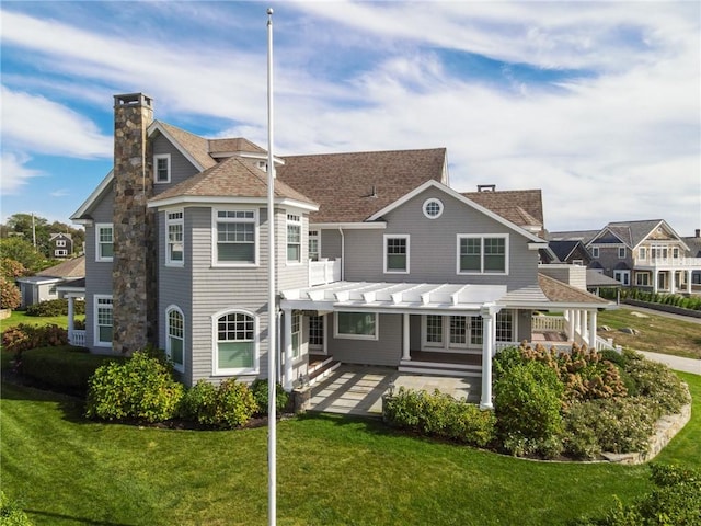 7 Fenway Rd, Westerly, RI 02891 - rear view of house featuring a pergola, a lawn, a chimney, and a patio area