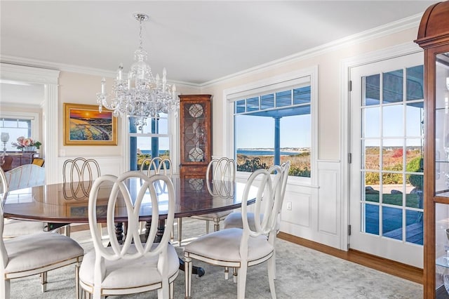7 Fenway Rd, Westerly, RI 02891 - dining space featuring a wainscoted wall, a notable chandelier, wood finished floors, a decorative wall, and ornamental molding
