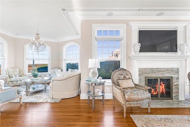 7 Fenway Rd, Westerly, RI 02891 - living area with a notable chandelier, wood finished floors, a premium fireplace, baseboards, and ornamental molding