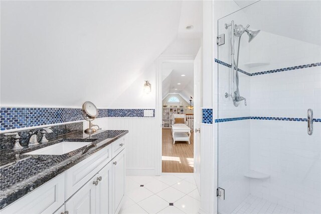 7 Fenway Rd, Westerly, RI 02891 - full bath with a shower stall, connected bathroom, vanity, a wainscoted wall, and tile patterned flooring