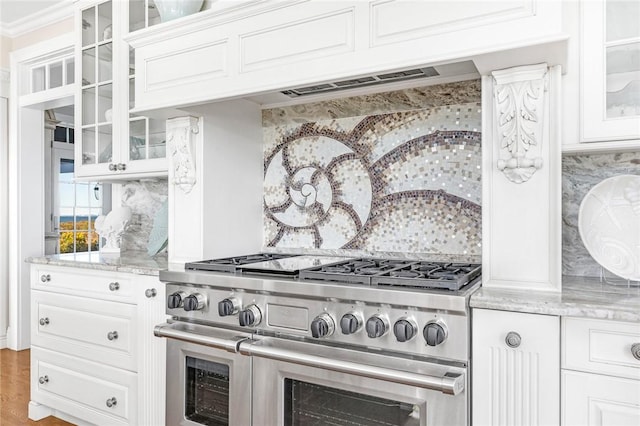 7 Fenway Rd, Westerly, RI 02891 - kitchen featuring white cabinets, tasteful backsplash, glass insert cabinets, wood finished floors, and range with two ovens