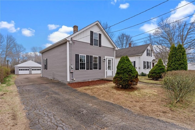 5 Cottage St, Westerly, RI 02891 - view of front facade featuring a detached garage, an outdoor structure, and a chimney