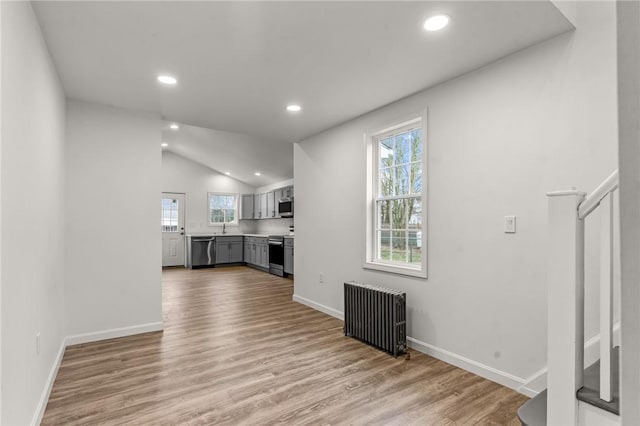 5 Cottage St, Westerly, RI 02891 - unfurnished living room featuring radiator, wood finished floors, baseboards, and recessed lighting