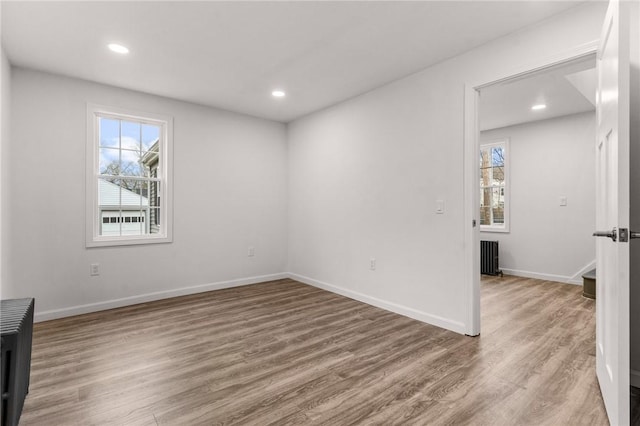 5 Cottage St, Westerly, RI 02891 - spare room with radiator heating unit, recessed lighting, and wood finished floors
