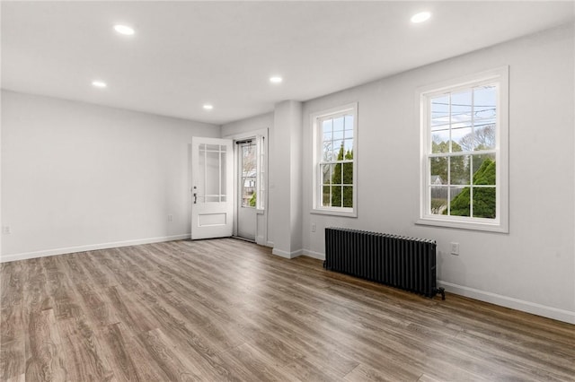 5 Cottage St, Westerly, RI 02891 - empty room with wood finished floors, radiator heating unit, and recessed lighting