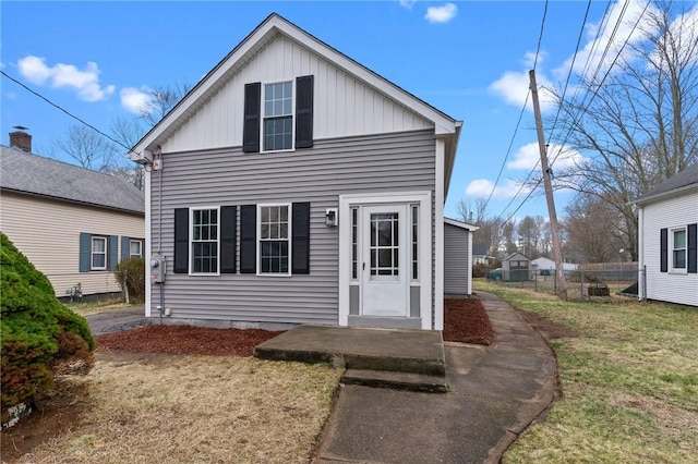 5 Cottage St, Westerly, RI 02891 - view of front of property with board and batten siding, fence, and a front lawn