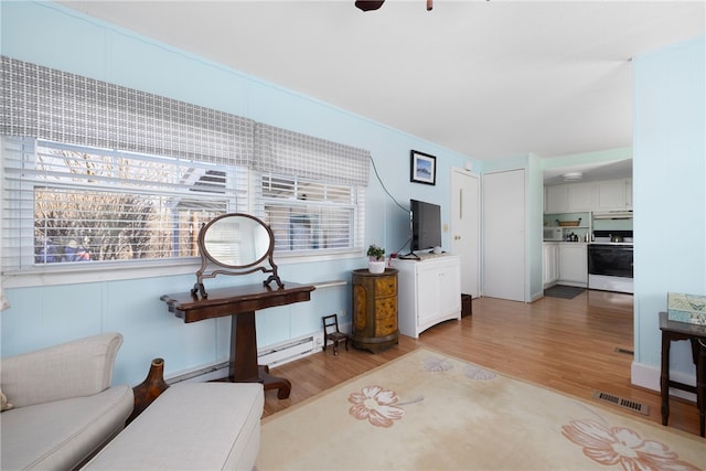 27 Woodward Rd, Lincoln, RI 02865 - living room featuring a baseboard heating unit, light wood finished floors, and visible vents