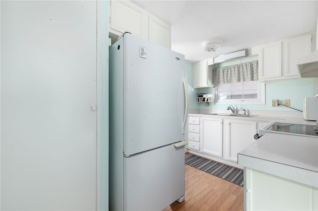 27 Woodward Rd, Lincoln, RI 02865 - kitchen featuring freestanding refrigerator, light countertops, white cabinetry, and range with electric cooktop