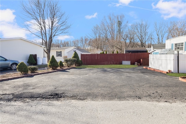 27 Woodward Rd, Lincoln, RI 02865 - view of parking featuring fence and aphalt driveway