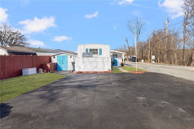 27 Woodward Rd, Lincoln, RI 02865 - exterior space with driveway, an outbuilding, fence, and a front lawn