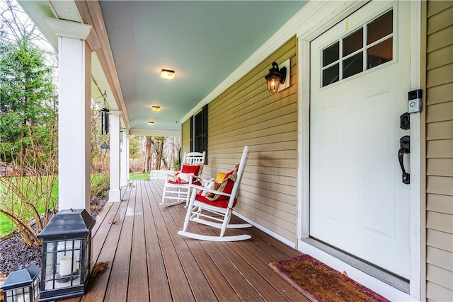 wooden terrace featuring covered porch
