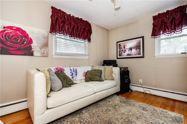 living area featuring a baseboard radiator and wood finished floors