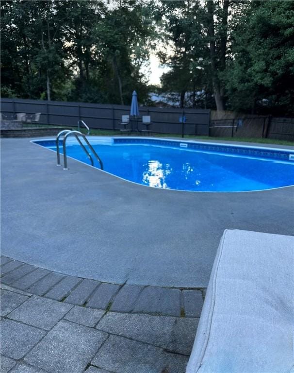 view of swimming pool with fence and a fenced in pool