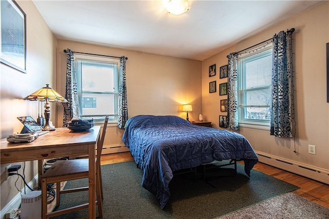 bedroom featuring baseboards and wood finished floors