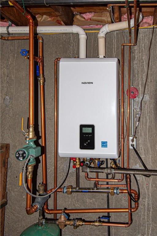 utility room with tankless water heater