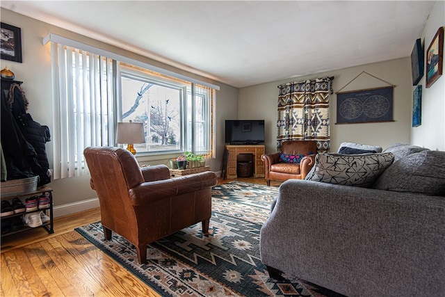 living area with wood finished floors and baseboards