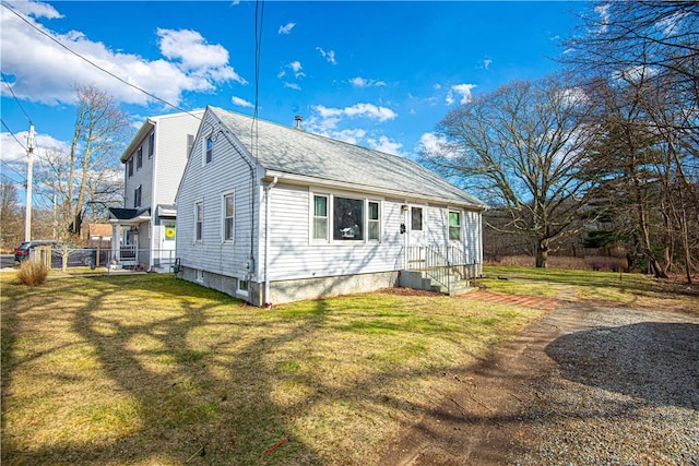view of side of property featuring a yard